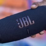 a hand holding a speaker