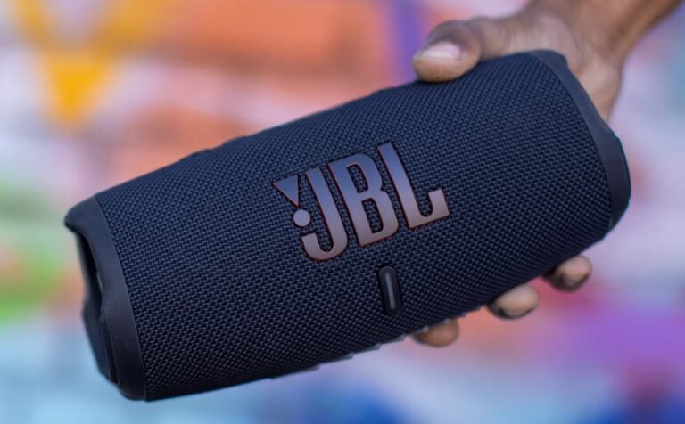 a hand holding a speaker