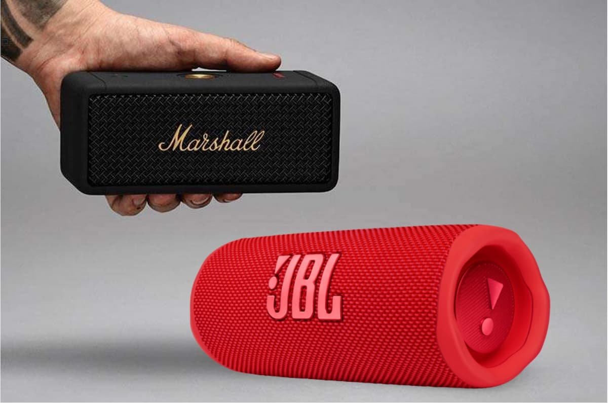 a hand holding a speaker next to a red speaker, jbl vs marshall comparison