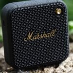 a black square speaker on a log