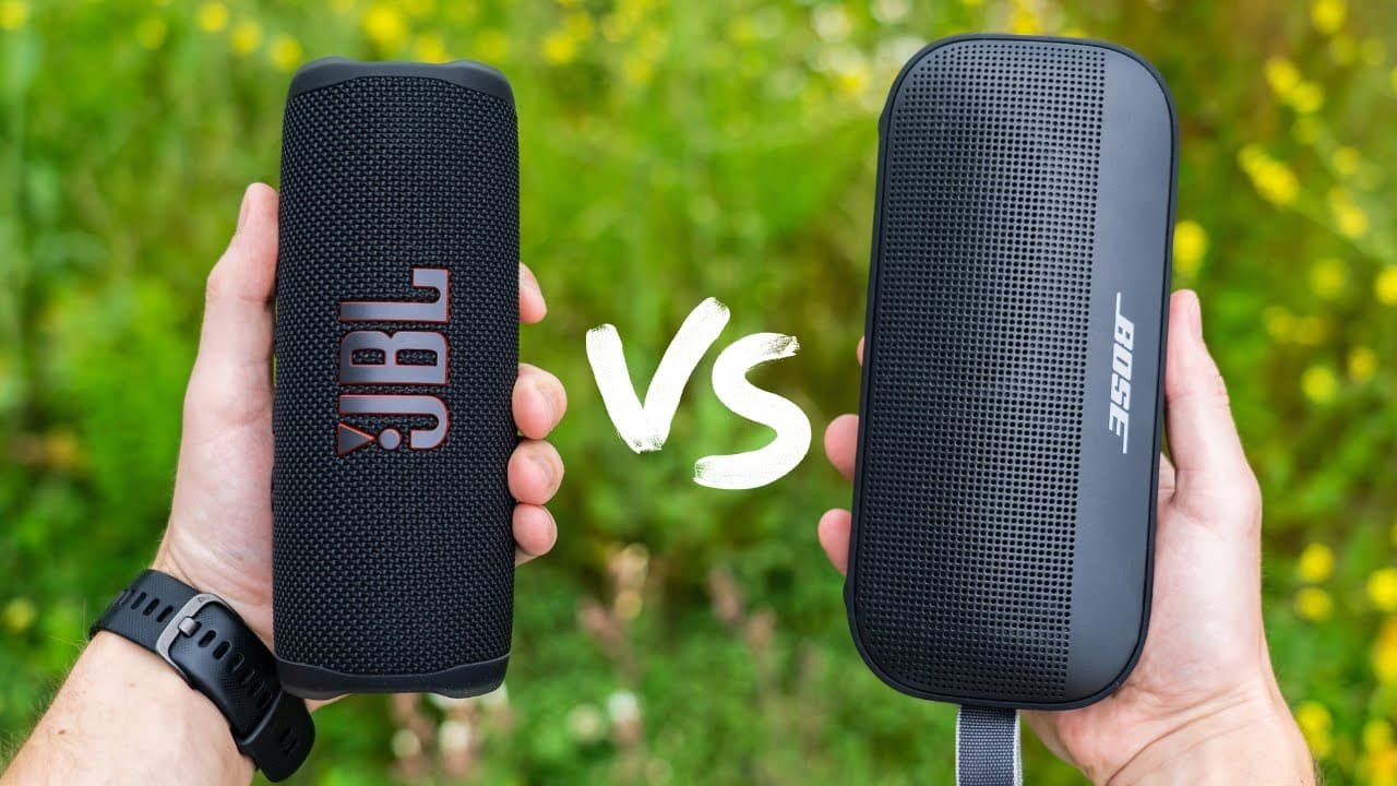 two hands holding a speaker, jbl vs bose